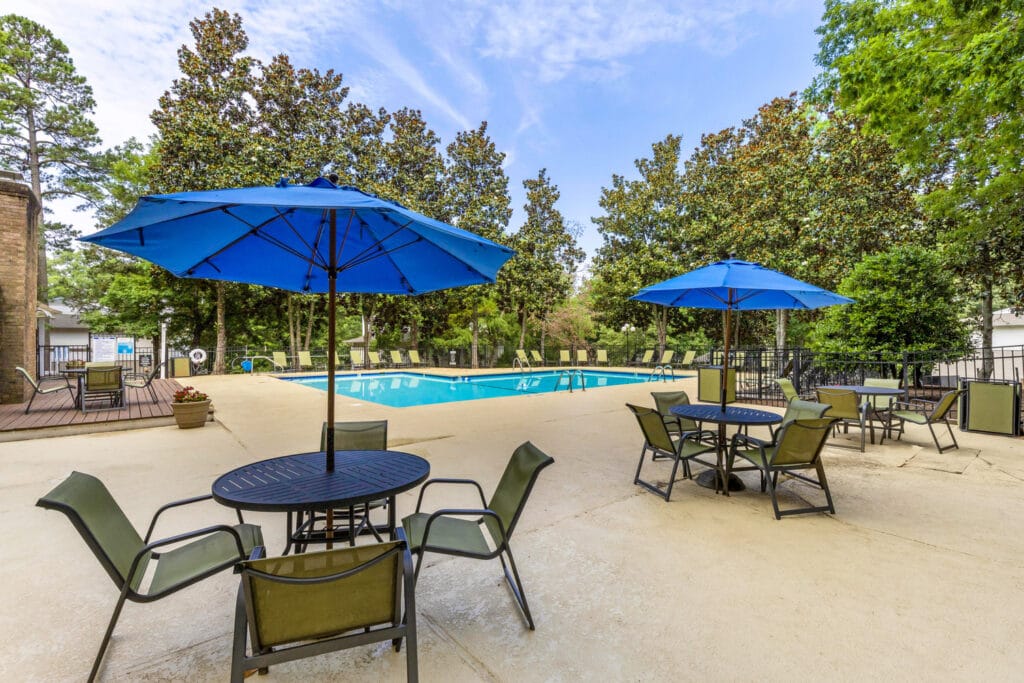 swimming pool with seating at tables | Woodlyn on the Green